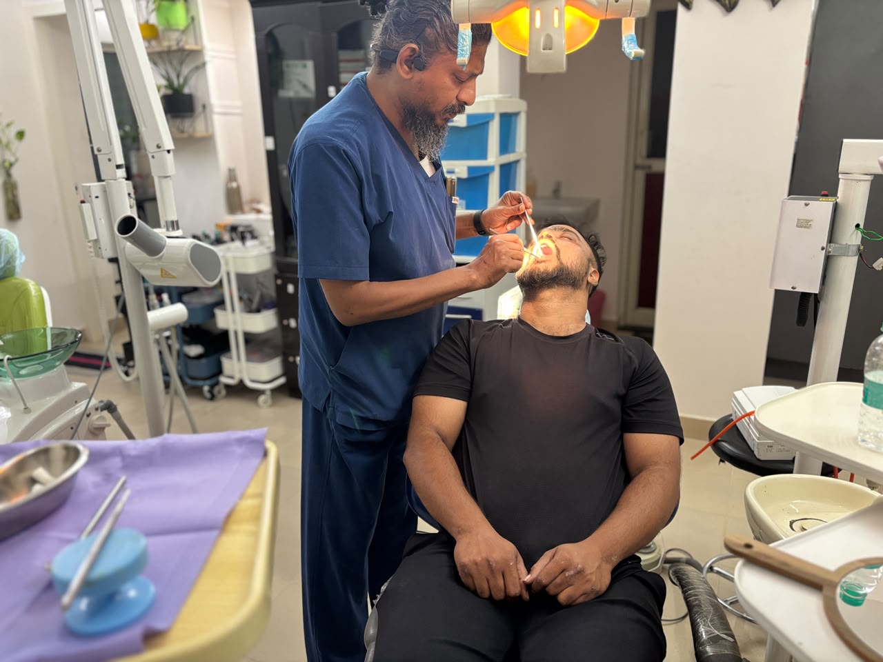 A dentist treating a patient chairside at DentEssencePro